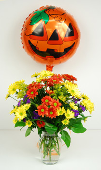 Send a Halloween greeting with our "Trick or Treat" bouquet. Our glass garden vase is filled with all of the colors of the season,  and tied with a Halloween mylar balloon.