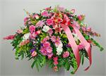 Our Affection casket piece arrangement is designed with pink roses, lavender spiders mums, stargazer lilies, pink carnations, white stock, lavender larkspur, green bells of Ireland, lavender spray daisies, mixed greens, purple statice and matching ribbons