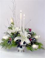Shinning and bright is the only way to describe this holiday centerpiece. This brightly colored red and silver striped vase is filled with red carnations, you favorite holiday evergreens, snow cover pines, flocked greenery, with holly, red ornaments, and 