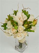 24 Champagne colored roses with gold accents, greenery and curly willow and wraped with matching ribbons.