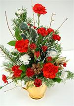 The charm of Colonial Williamsburg comes alive in this stunning golden ceramic pitcher. Gleaming like the first snow fall, and filled with the colors of Christmas, bright red carnations, snow white mini carnations, holiiday evergreens, pine cones and holl