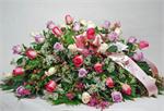 An elegant all-rose casket spray in shades of pink is a majestic, yet traditional, display of sympathy. A loved one has passed, but the memory of many happy times together will last forever.