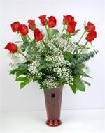 12 premium long stem red roses arranged in a ruby red glass 