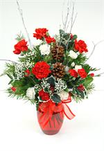 This classic holiday red vase is filled with red and white carnations, holiday evergreens, pine cones, holly and baby breath is a sure way to say 