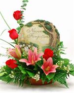 Our Never Forgotten Garden is designed around a keepsake stepping stone with easel and arranged with purple aster, red roses with stargazer lilies, million star gyp and mixed greens.
