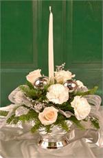 Our “Opal Frost” centerpiece says it all, it’s time to celebrate. Made with frost colored roses, snow white carnations, ice branches, silver leaves with mixed holiday greenery, silver oraments and a white candle all arranged in a silver container.