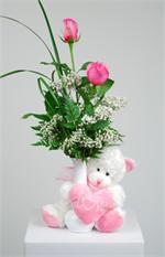 Your favorite valentine will be “tickled pink” when she receives this charming valentine. This soft and cuddly white bear with a pink love heart and holding a white bud with two pink roses says it all. Don’t keep you valentine waiting call today.