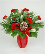 Just in time for the holiday season, tulips. Snow white tulips mixed with holiday red carnations with a mix of holiday greens, holly, snow tipped pine cone all arranged in a bright red matt finished glass vase. Need it today, no problem. We offer sane day